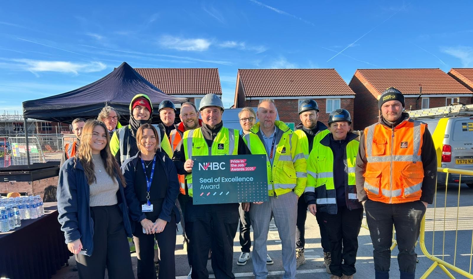 Site Manager Paul Jezusek (left-centre) beside Construction Director Lee Kilby (right-centre) and the De Maulay Manor site and sales staff.